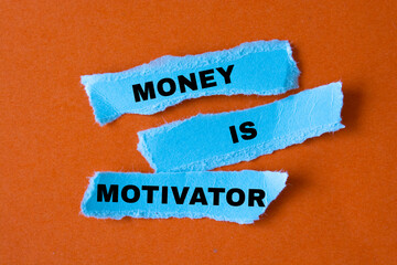 MONEY IS A MOTIVATOR message written torn paper.