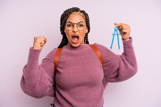 black afro woman shouting aggressively with an angry expression. measure compass student concept