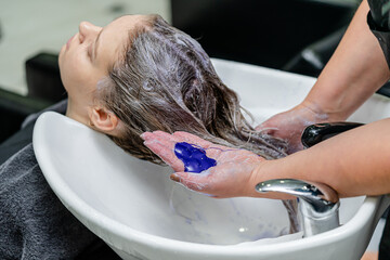 Set of hair bleaching process. Hair stylist using purple shampoo after hair lightening.