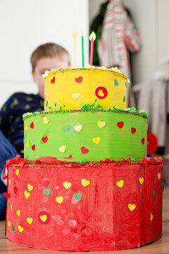 Lithuanian flag color cake. Paper birthday cake painted with gouache. Decorated with punch paper and other home made decorations and glitter.