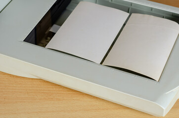 Digitization of a family photo album. Two paper photos lie on a