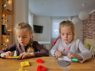 Fototapeta premium Little girls modeling something from clay.