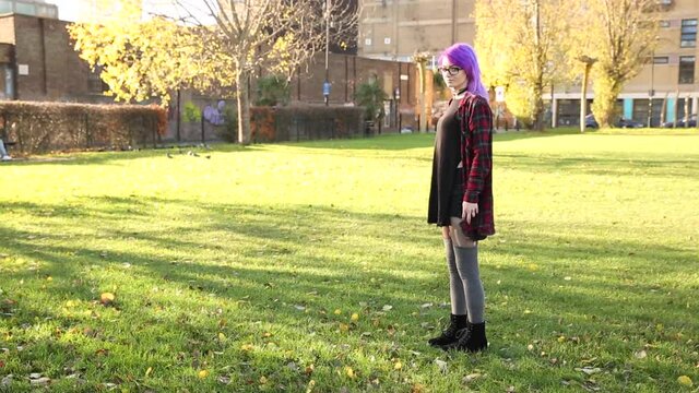 Alternative young woman in London walking and having fun at park