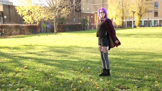Alternative young woman in London walking and having fun at park