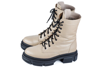 Beige winter leather boots . Fashionable modern female Shoes Made of tan Leather. Woman's Military Style Boots.