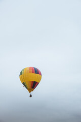 Colorful hot air balloon flying on a cloudy winter day