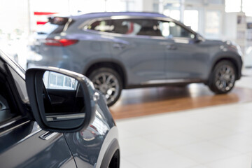 Fototapeta premium New modern unknown cars at dealer showroom. Themed blur background with blur effect. Car auto dealership. Prestigious vehicles.