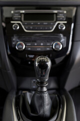 New modern unknown car with manual transmission. Modern transportation. Themed blur background. Close up.