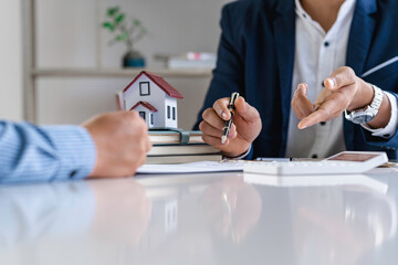 Real estate agents and clients are signing contracts and discussing home purchases, insurance or real estate loans.