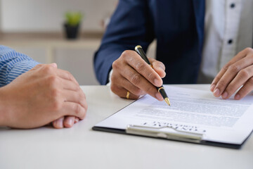 Real estate agents and clients are signing contracts and discussing home purchases, insurance or real estate loans.