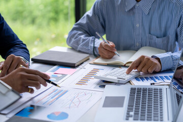 Business team people discussing analyzing investment charts the charts and graphs showing the results of their successful teamwork, typing keyboard, texting message, analyze graph plans