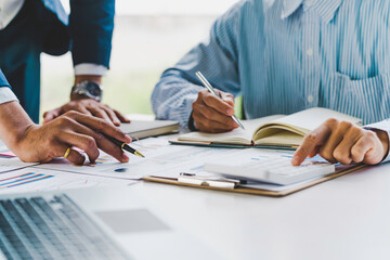 Business team people discussing analyzing investment charts the charts and graphs showing the results of their successful teamwork, typing keyboard, texting message, analyze graph plans