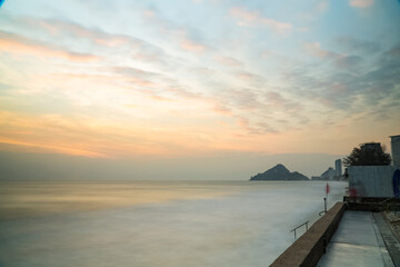 Beautiful long exposure seascape of smooth wavy sea and cloud. horizon with first sunset sky.