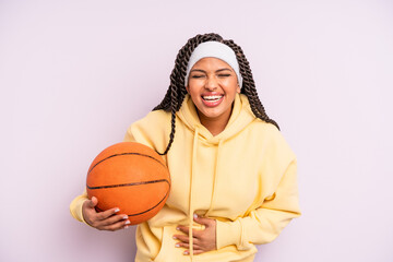 black afro woman laughing out loud at some hilarious joke. basketball concept