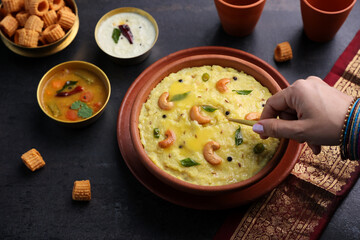 Ven Pongal Khara Pongal Sambar coconut Chutney woman hand serving Indian breakfast food Tamil Nadu festival Pongal Sankranti Diwali spicy pongal using rice lentil semolina rava South India Sri Lanka