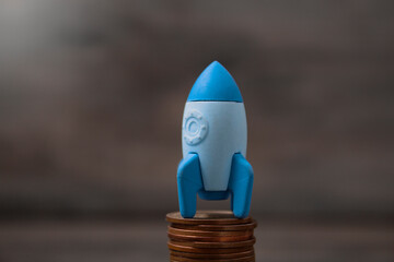 rocket on coins. concept startup