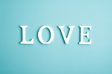 Word love on blue background. Happy Valentines Day concept. Minimal style.