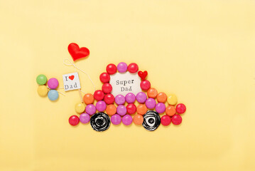 Greeting with sweets for Fathers day on yellow card.