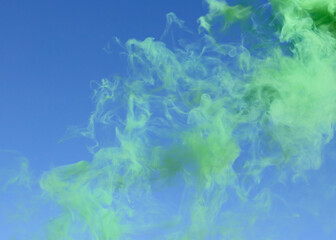 Fototapeta na wymiar Green smoke on a blue background.