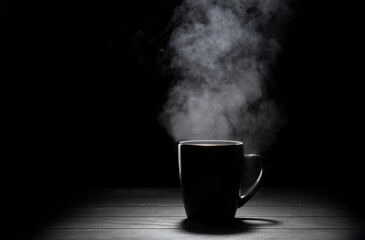 Steaming cup on black background.