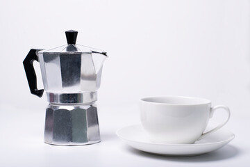 Moka pot and coffee cup on white background
