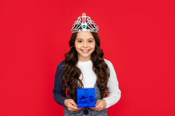 happy child in queen crown. princess in tiara hold box. kid with present.