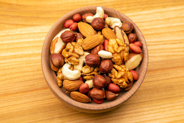 assorted nuts on a kitchen wooden board. vitamin vegetarian food