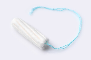 Medical female tampon on a pink background. Hygienic white tampon for women. Cotton swab. Menstruation, means of protection. Tampons on a red background.