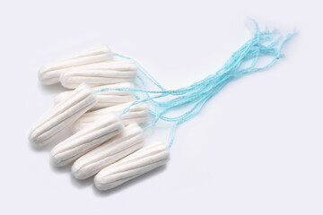 Obraz na płótnie Canvas Medical female tampon on a pink background. Hygienic white tampon for women. Cotton swab. Menstruation, means of protection. Tampons on a red background.