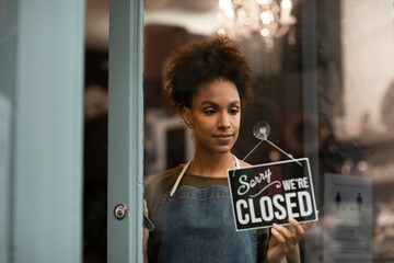 Portrait of store owner closing store