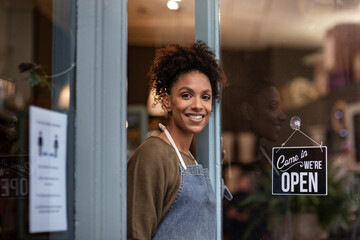 Portrait of store owner open for business