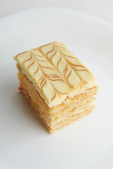 Slice of traditional Hungarian and Austrian Esterhazy cake on white background