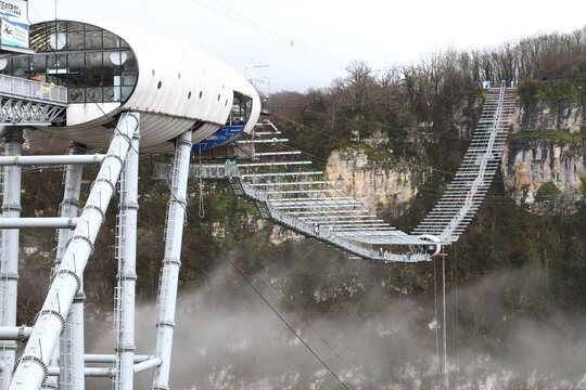 SKYPARK, SOCHI, RUSSIA - 02 JANUARY 2022:  AJ Hackett Sky Park on mountain forest background. The longest suspension footbridge and extreme activities.