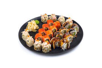 Set of brolls with cheese, eel, shrimp and salmon on black round plate on white background. Lots of rolls with eel, salmon and cheese with flying fish caviar view.