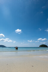 Kata beach in Phuket, Thailand, beach with clear water, white and golden sand, blue sky, in tropical vacation area.  a beach holiday  photo with copyspace.