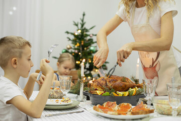 A festive New Year's table, on the table a Christmas turkey with oranges, aromatic herbs and cranberries