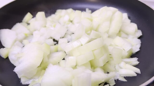 Frying onion in a pan. 4k video recipe
