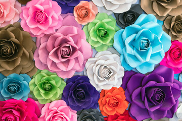 Rose made from paper. Handmade roses backdrop. Collection of many colorful origami roses forming a beautiful floral pattern background. Artificial colorful flowers paper background. Paper craft.