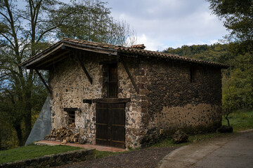 stone house with mountains in the background, fageda d'en jorda, catalonia