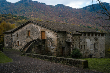 Fototapeta na wymiar stone house with mountains in the background, fageda d'en jorda, catalonia