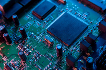 Fototapeta premium Microcircuit with chip close up with neon lighting. Chip shortage