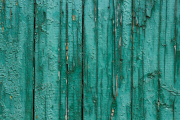 Fototapeta na wymiar Old wooden damaged green fence as background.