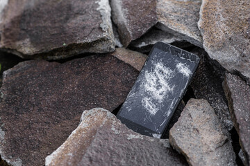 A broken cell phone. Cracked smartphone screen.