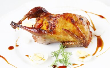 baked quail stuffed with corn grits and sun-dried tomatoes. holiday dish