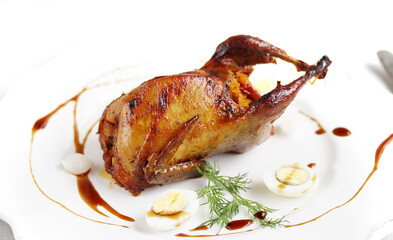 baked quail stuffed with corn grits and sun-dried tomatoes. holiday dish