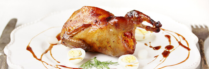 baked quail stuffed with corn grits and sun-dried tomatoes. holiday dish