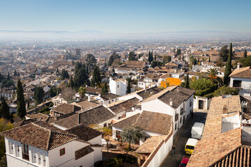 A view from Granada of the Alhambra from Paseo de los Tristes. It's a sunny day in Granada in december 2021