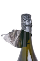 Top of a champagne bottle with a closed stopper and a printed foil package. Isolated on a white background, close-up.