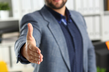 Businessman working in the office, reaching out hand forward for handshake