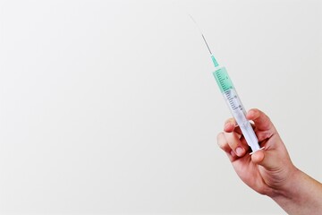 A doctor holds vaccine against new covid-19 omicron variant on a background